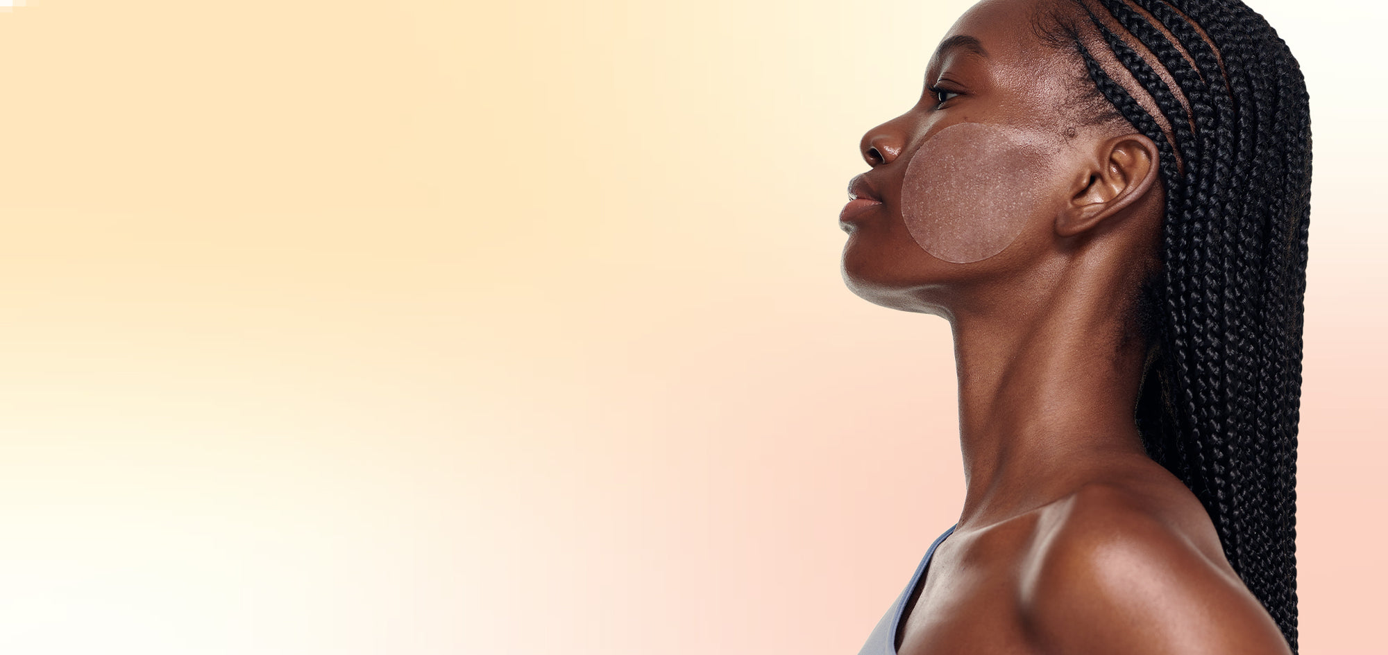 Side profile of a woman with braided hair on a beige background